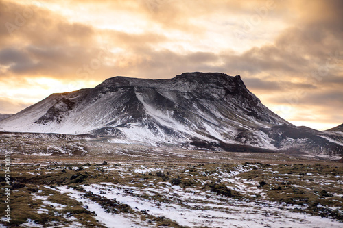 Snowy Icelandic mountains with dramatic cloudy sky