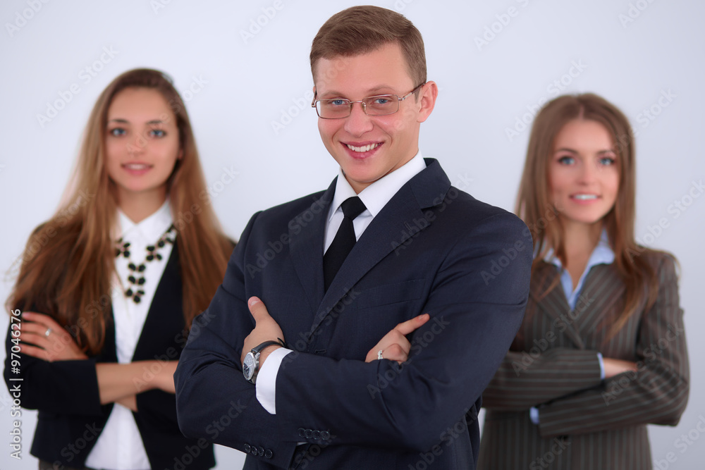 Cheerful business man with colleagues in the background, start up team Cheerful business man with colleagues in the background, start up team