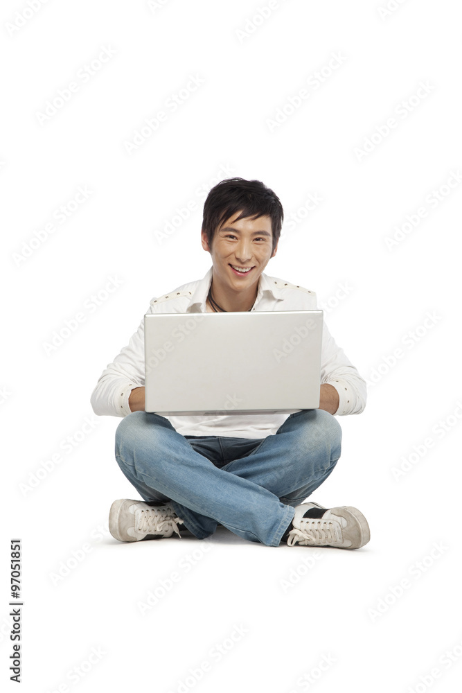 Young man using a laptop computer Young man using a laptop computer