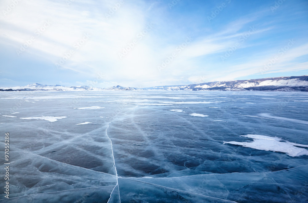 Fototapeta premium Winter ice landscape on lake Baikal with dramatic weather clouds