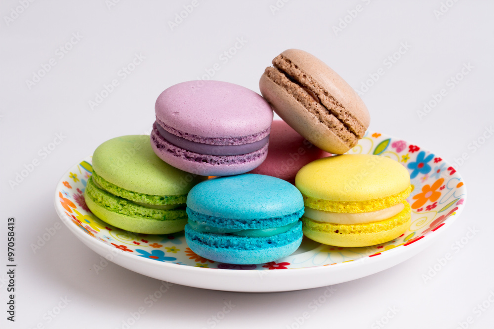 Fototapeta premium Collection of brightly colored French macarons on white background