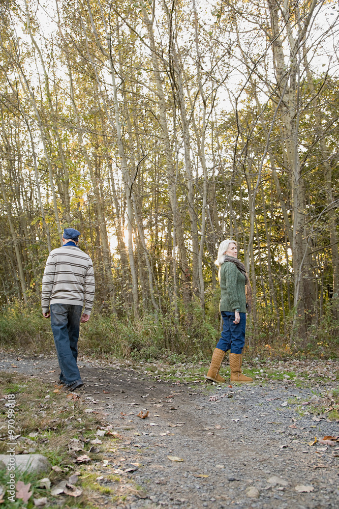 Mature couple walking in a forest Mature couple walking in a forest