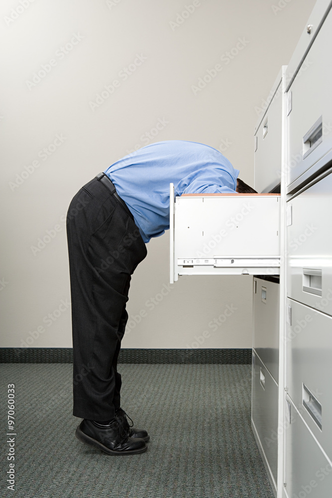 Photography Man looking in filing cabinet
