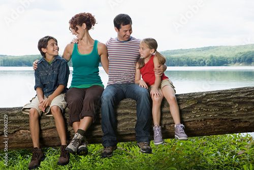 Family sitting on a log