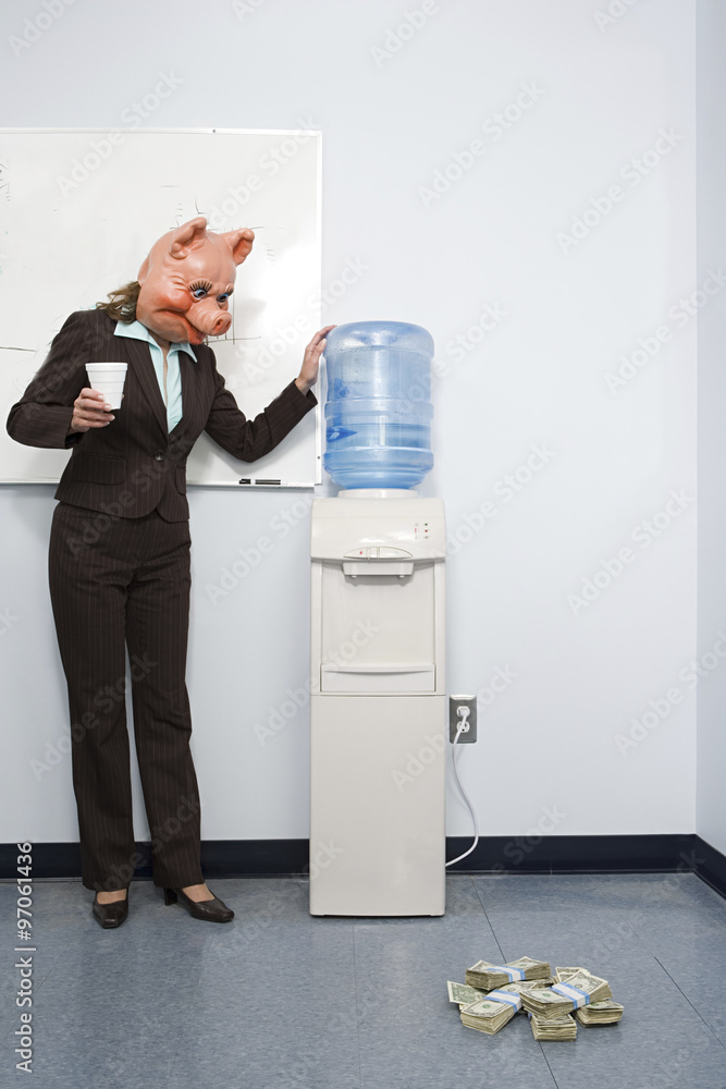 Businesswoman in pig mask looking at money