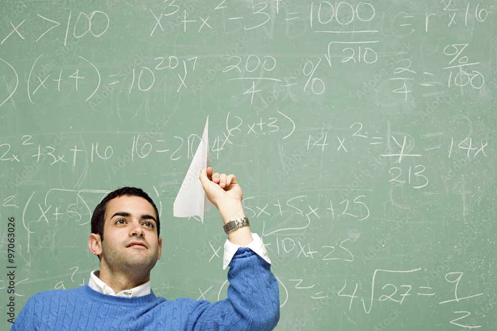 Male student throwing a paper aeroplane Male student throwing a paper aeroplane