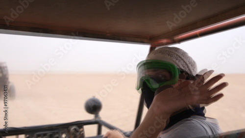 Girl says hi from traveling through the desert buggy