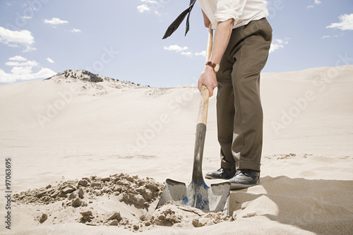 Man digging in desert