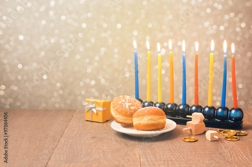 Jewish holiday Hanukkah celebration with menorah over bokeh background. Retro filter effect photo