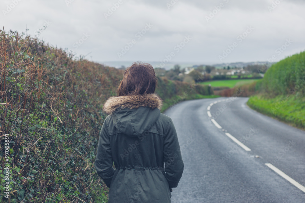 Woman walking on country road