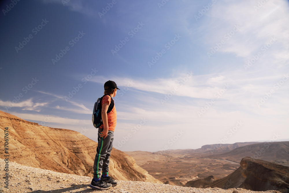 Cute 8 years old boy hiking in the desert Cute 8 years old boy hiking in the desert