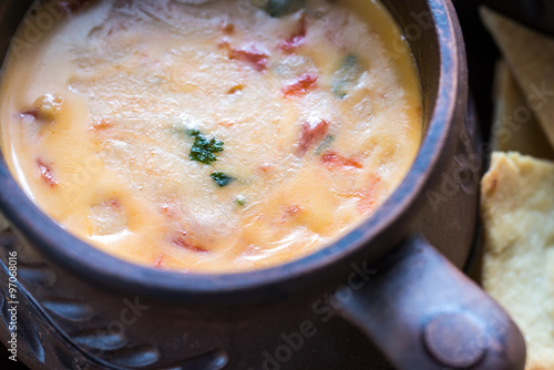 Bowl of queso with tortilla chips photo