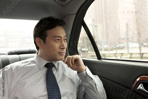 Businessman looking out car window © xixinxing