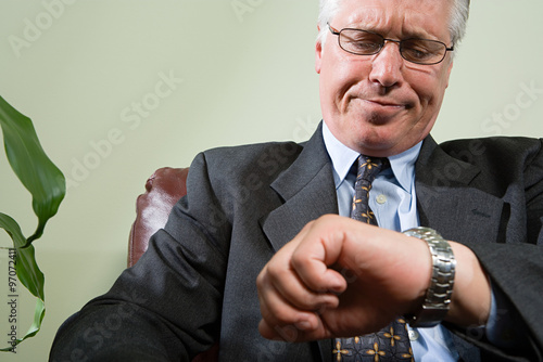 Fotografija Man looking anxiously at watch