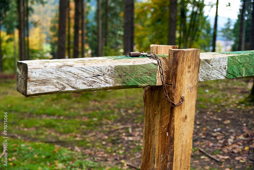 Closed with lock barrier bar gate in the forest Closed with lock barrier bar gate in the forest