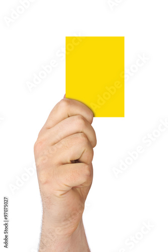 Hand holding a yellow card