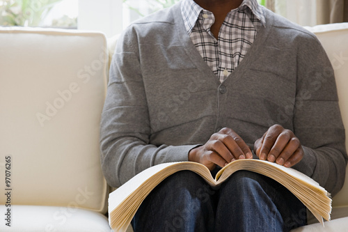 Photography Blind man reading a braille book