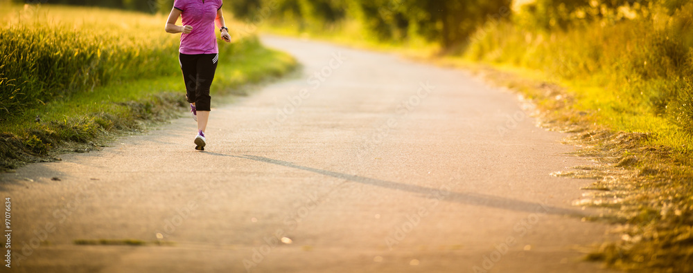Detail of legs of a female runner on road - jog workout/well-bei - obrazy, fototapety, plakaty 