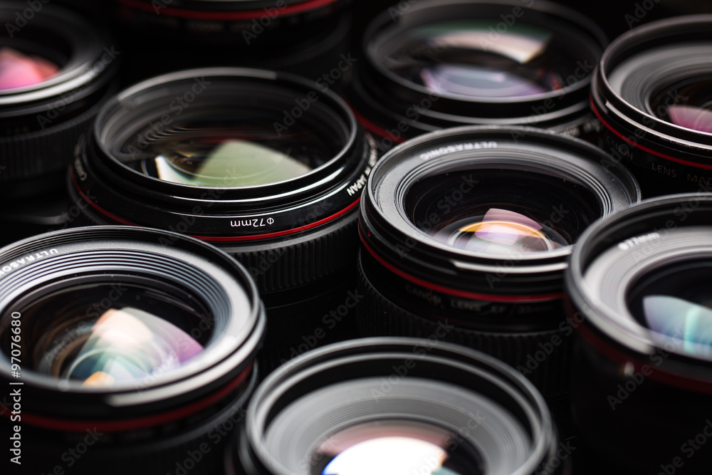 Modern camera lenses with reflections, low key image Modern camera lenses with reflections, low key image