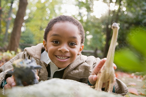 Boy with toy dinosaurs photo