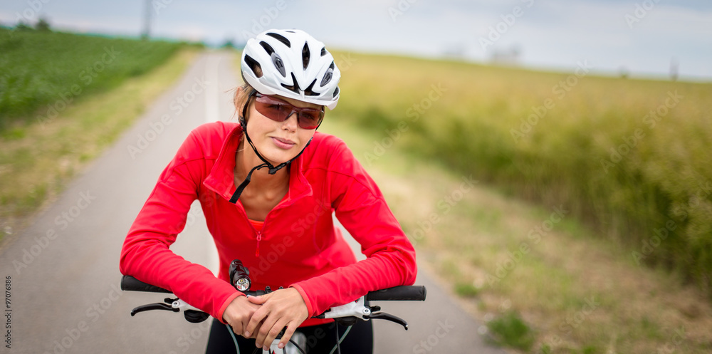 Pretty, young female biker outdoors on her mountain bike