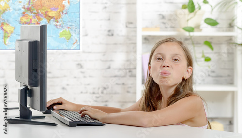Foto young school girl grimaces in the classroom