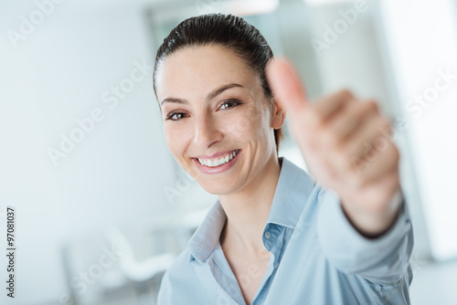 Beautiful businesswoman thumbs up