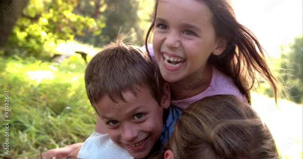 Young couple and kids having fun together outdoors Young couple and kids having fun together outdoors