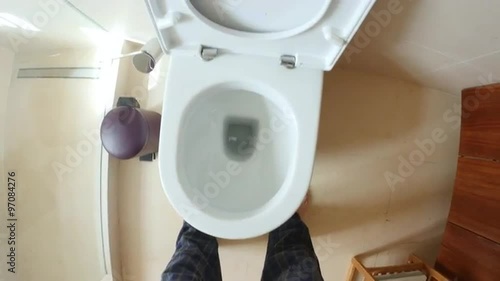 Point of view of man going to and using the toilet
