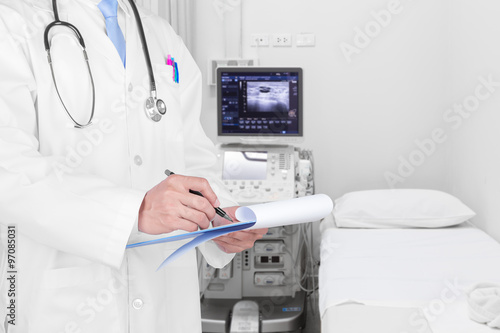 Doctor writing a medical prescription with medical background