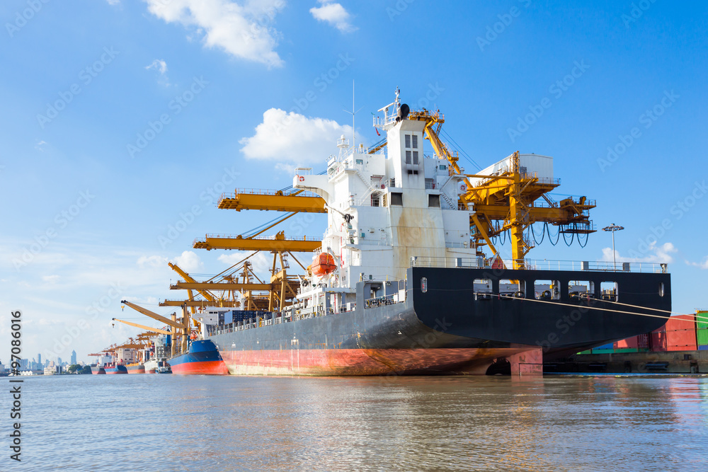 Fototapeta premium Container cargo freight ship with working crane loading bridge 