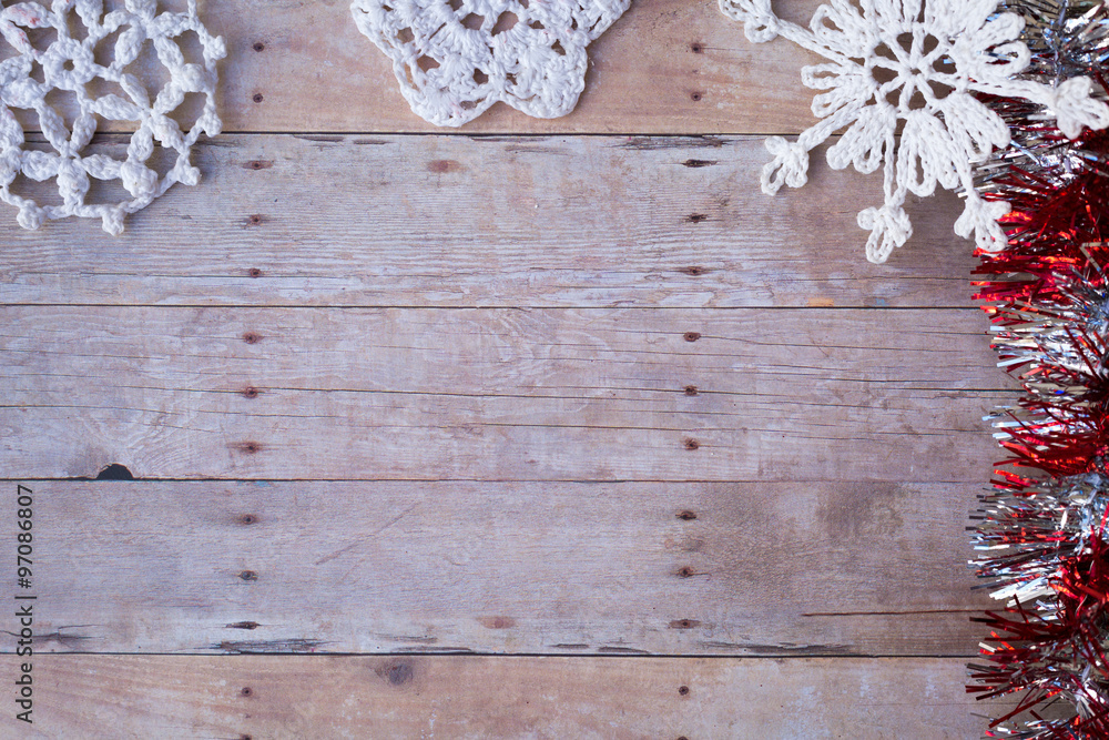 Snow flake Ornaments on a wood background.
