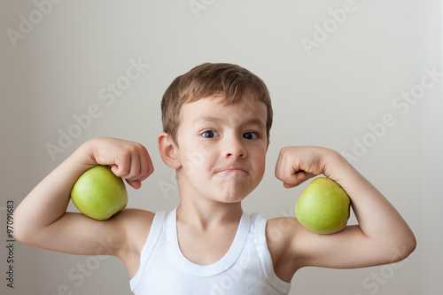 boy with apples show biceps