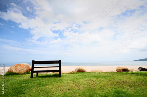 A Wooden Bench Near a White Sand Beach Looking to the Ocean