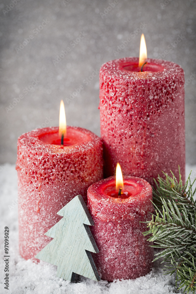 Three red candles on gray background, Christmas decoration. Adve Three red candles on gray background, Christmas decoration. Adve
