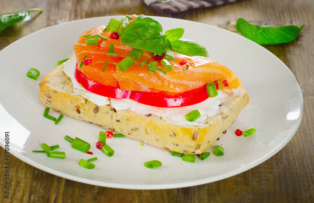 Sandwich with cereals bread and salmon on a old wooden backgroun Sandwich with cereals bread and salmon on a old wooden backgroun