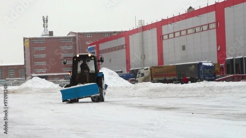 Removing snow with plow, close up of iron snowplow pushing a lot of snow away