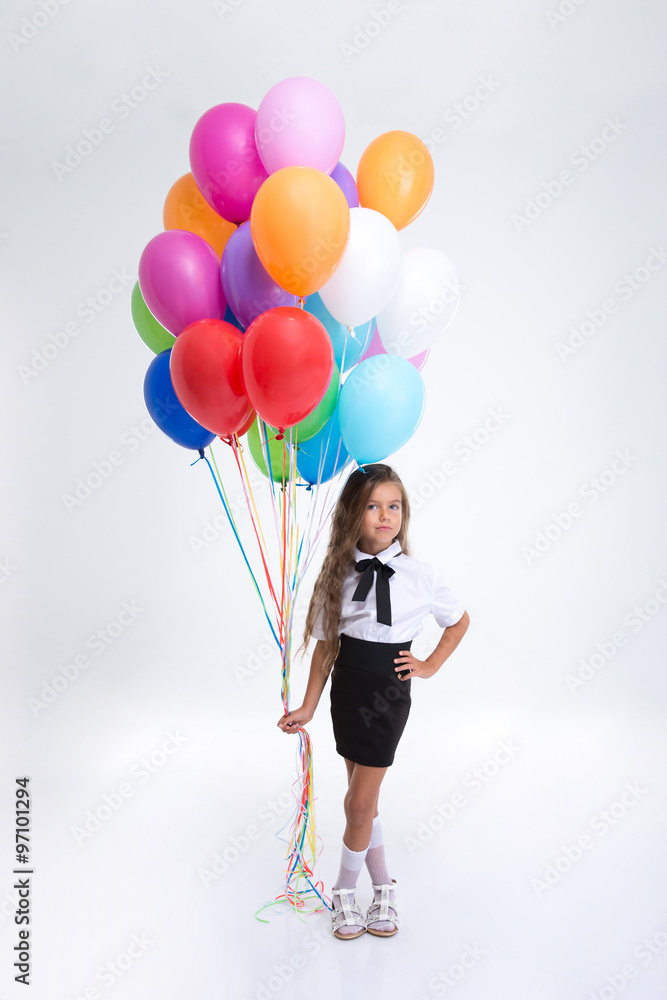 Pretty little school girl standing with balloons Pretty little school girl standing with balloons