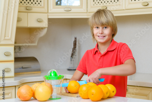 Funny teenager with citrus. Boy holding fruit oranges
