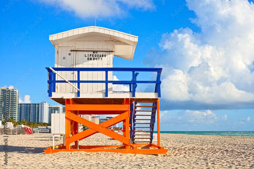 Miami Beach Florida, USA famous tropical travel location, typical Art Deco lifeguard house on a beautiful summer morning with ocean and blue sky