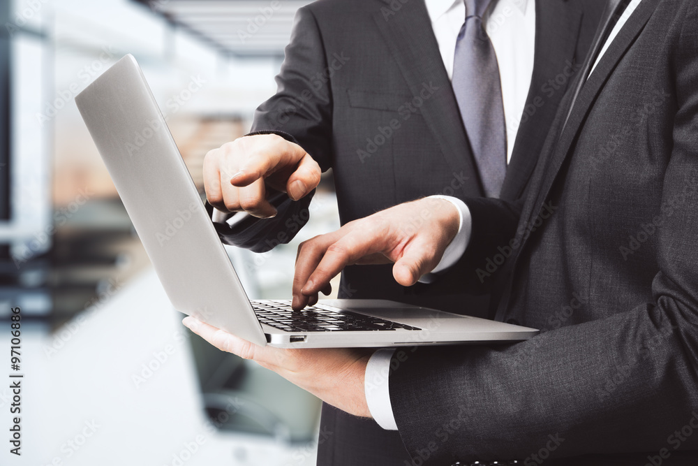 Two businessmen working with laptop Two businessmen working with laptop