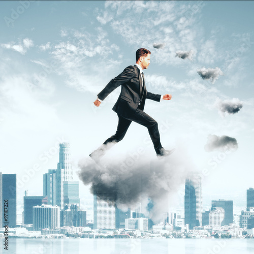 Businessman climbing thecloud ladder at city background concept