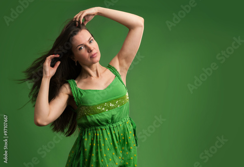 young beautiful caucasian brunette in green dress