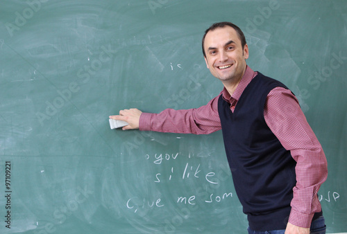 Teacher in the classroom board cleaning.