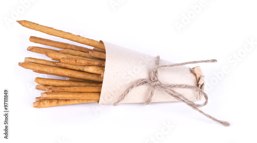 Salted sticks in a paper bag isolated. The sticks of paper in th