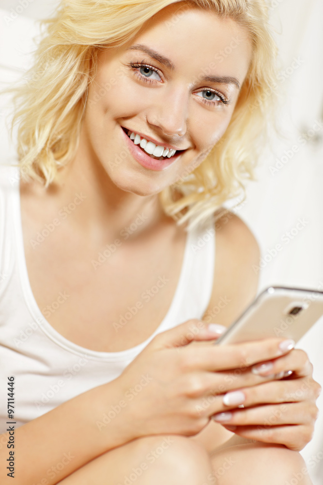 Young woman texting at home Young woman texting at home
