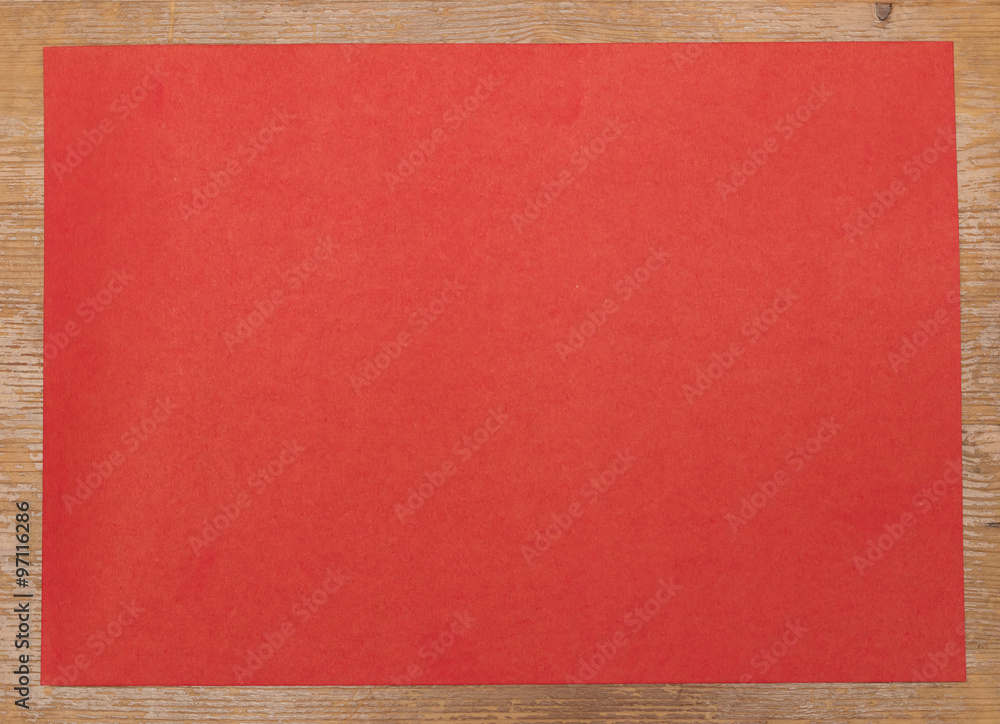 Red paper on wooden background