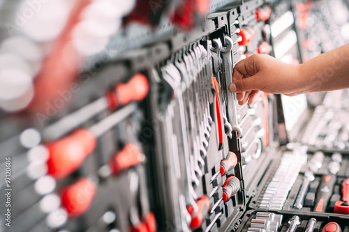 Worker at the store chooses wrench tools