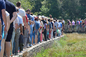 a group of people standing in line at the park