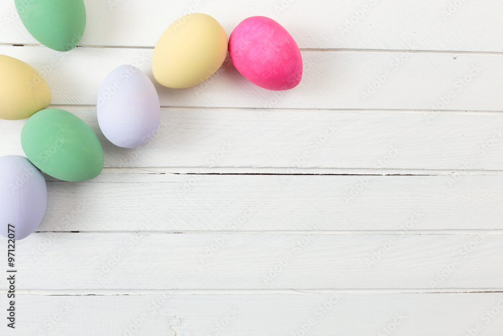 Easter eggs painted in pastel colors on white wooden background Easter eggs painted in pastel colors on white wooden background